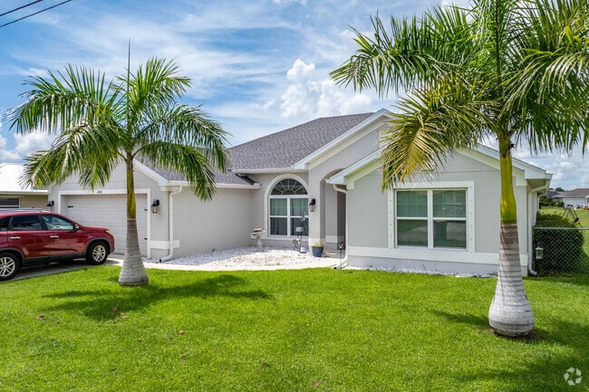 Lawns in Deep Creek are well kept and shaded by tropical palm trees.