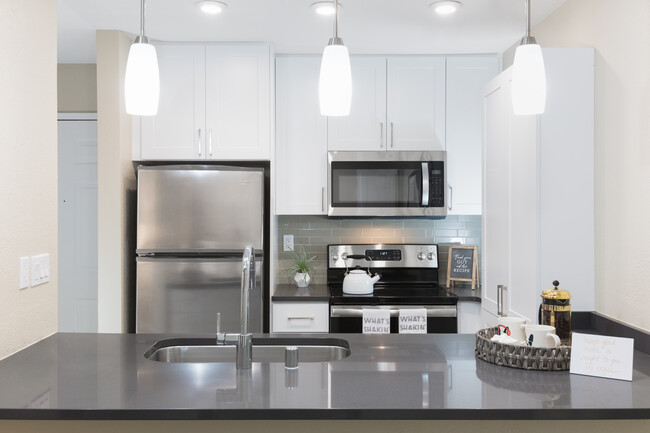 Modern Collection Kitchen With Quartz Countertops Ceramic Tile Backsplash And Stainless Appliances
