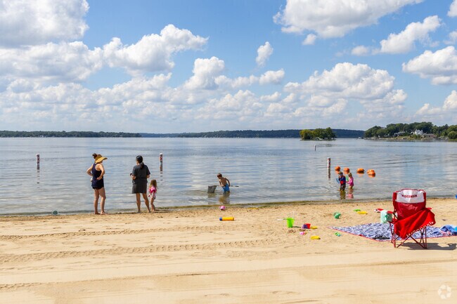 The beach at Pewaukee Lake often draws families from Pewaukee Village for lakeside recreation.