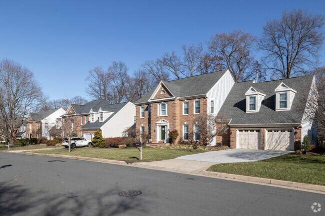 Inviting brick colonial homes line the street of Oak Hill.