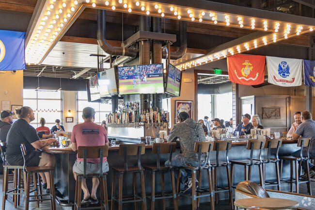People enjoy sports at Sidewinder's bar in King Arthur Park.