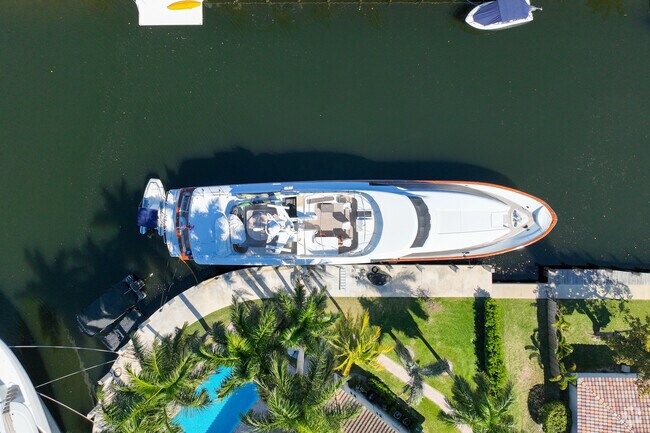 Bird's eye view of a yacht docked outside of a home in Sunrise Key.