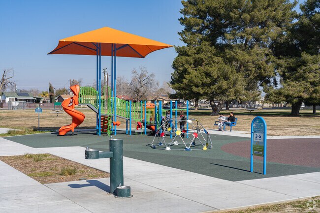 Local families enjoy the safe, new play equipment at Casa Loma County Park.