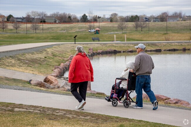 Carpenter Park has a large pond bordered by a paved walking path.