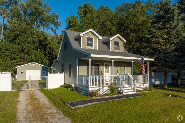 Watch the sun set from the large front porch on this Clio home.