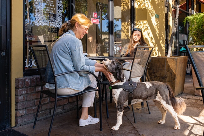A Prefumo mother enjoys her morning coffee with her daughter and grandpuppy.