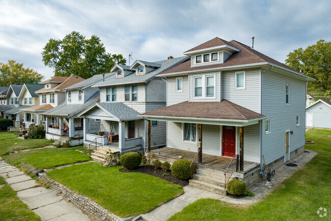 Many homes are traditional front-gabled bungalows with Craftsman-influenced columns.