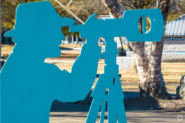 The parks on the river walk feature a series of cutout statues in different poses.
