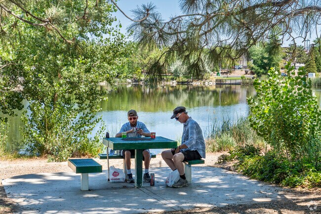 Locals of Oddie Boulevard enjoy the shade near the ponds at Paradise Park in the heat of summer.
