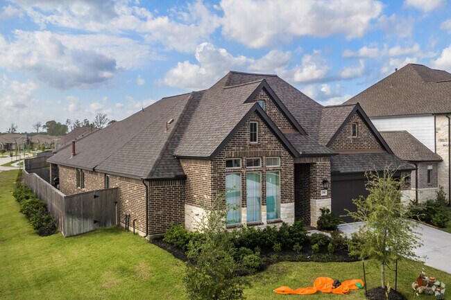 A one-story, Craftsman-style house with a manicured lawn in the Roman Forest neighborhood.