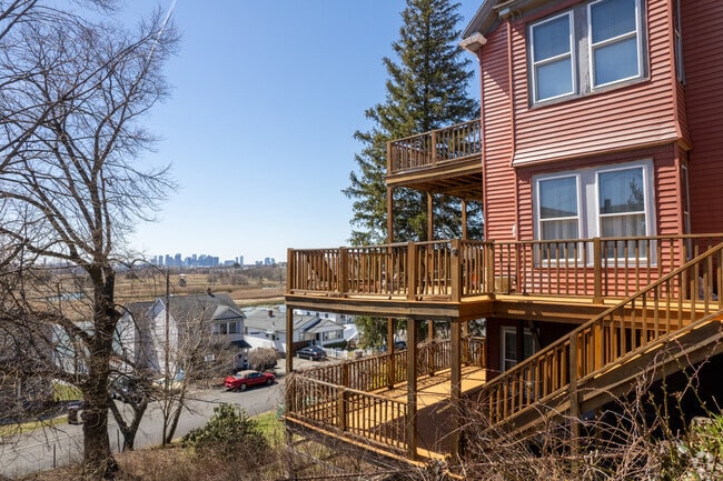 A waterside home with decks has views of Boston yet is located in Winthrop Highlands.