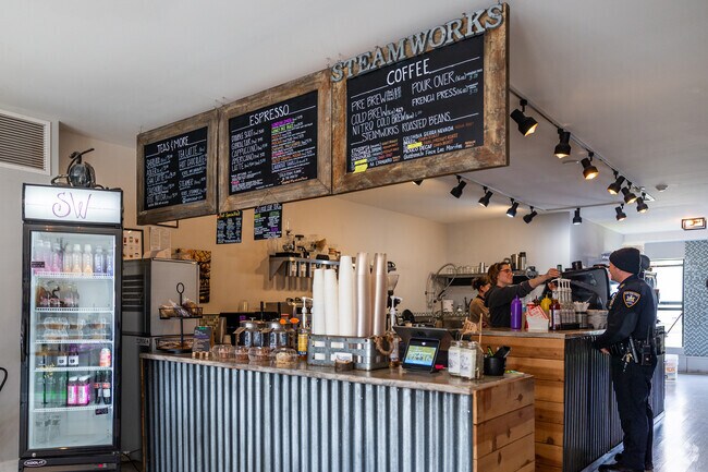 A barista serves an officer some fresh coffee at Steamworks Coffee in Lockport.