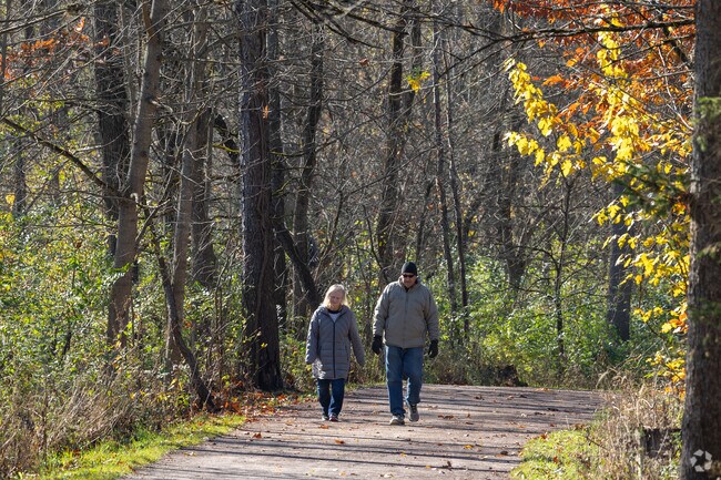 Residents of Richfield strolling through the park's vibrant foliage.