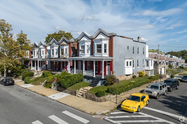 Brick rowhouses in Winchester show mixed renovation levels and modest front porches.