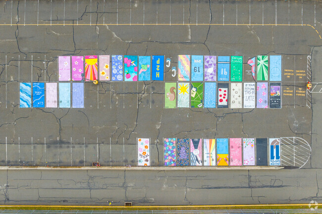 Students leave paintings on the parking spaces at Burrell High School.