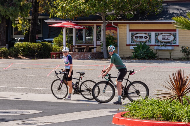 Two Highland cyclists pause on Foothill Boulevard before finishing their morning ride.