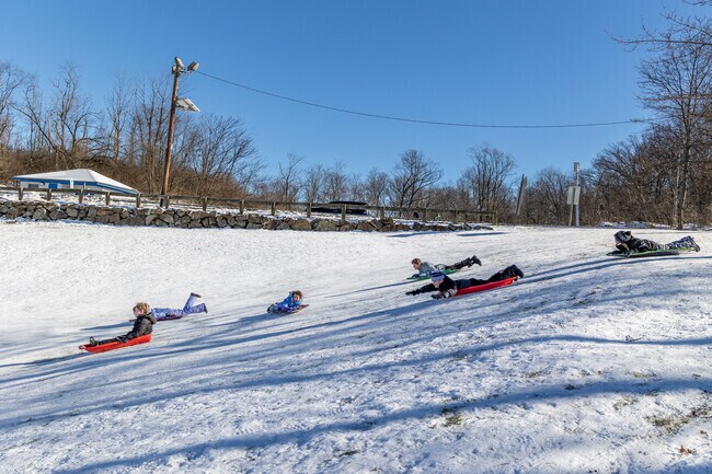 North Caldwell kids having fun sliding on snow at Mountain Avenue Field.