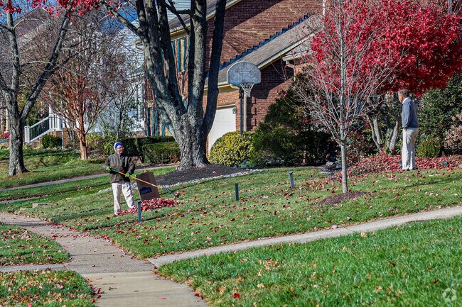 Neighbors in Harrods Hill help each other out during Autumn leaf-raking season.