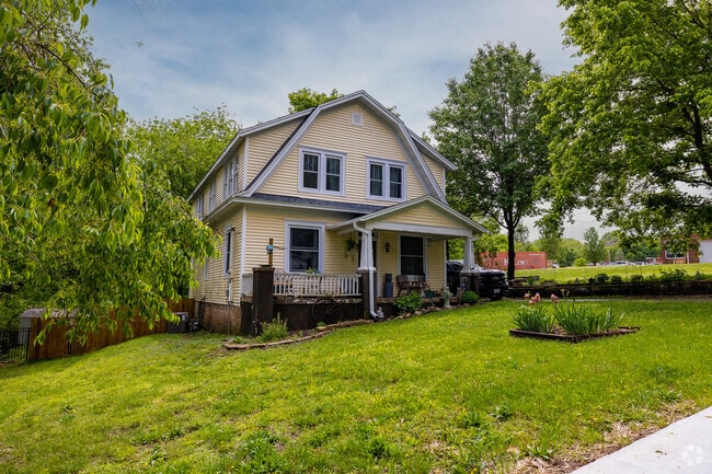 A stately Dutch Colonial Revival home in a residential area of Christian County.
