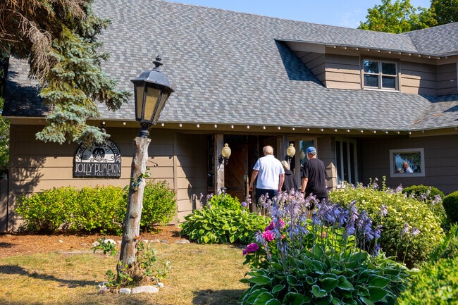 Jolly Pumpkin’s front lawn blooms with flowers outside its 1880s Bowers Harbor Inn building.