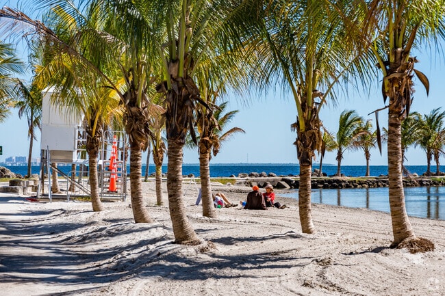 Residents of Gables By The Sea swim at the Atoll Pool beach in Matheson Hammock Park.