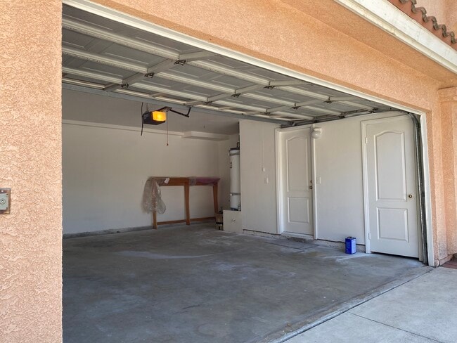 2-Car Garage with entrances to storage room and kitchen