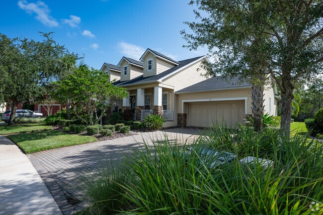 A welcoming front porch and dormer windows are charming elements of this Colonial Revival home.