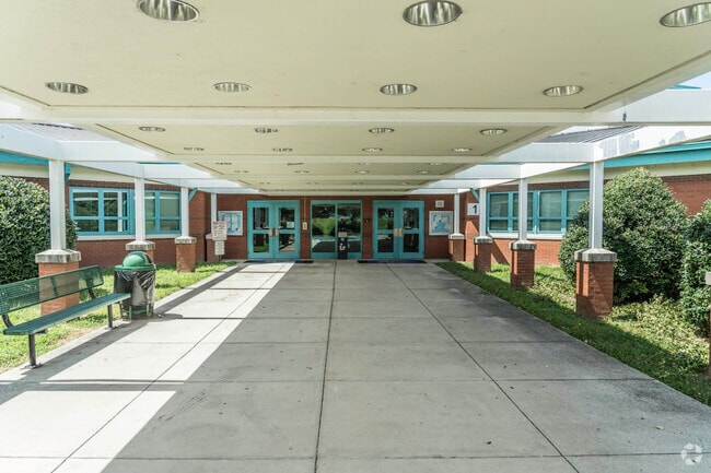 A large covered entrance keeps students out of the sun or rain at Lucille M. Brown Middle.