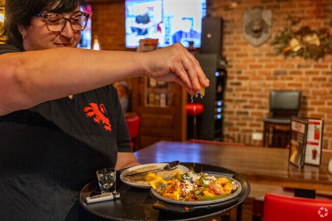 The Village Squire offers fun appetizer items like OPA flaming shrimp.