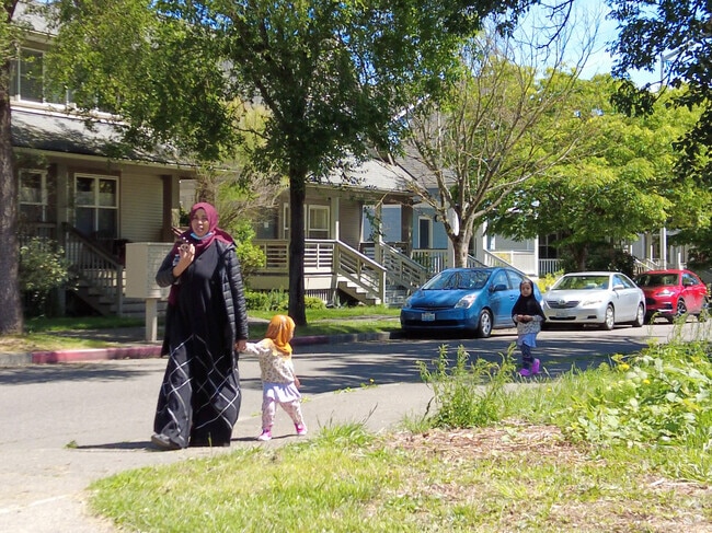 Residents enjoy a walk in the NewHolly neighborhood.