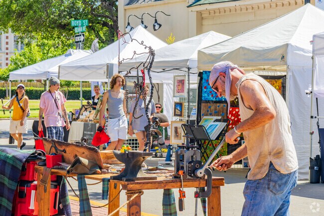 A metal artist creates his artwork on-site during the May Fair Arts Festival.