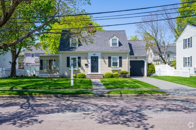Quiet streets feature quaint Cape Cod style homes with grassy front lawns.