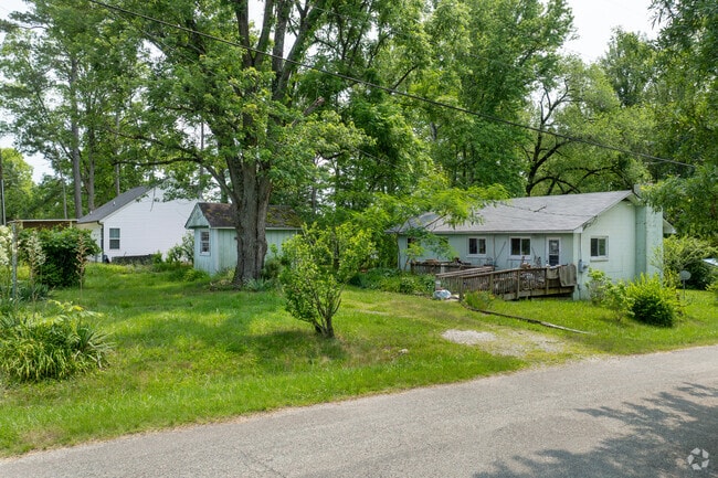 Shaded by trees, rows of ranch-style homes line the quiet streets of Columbia, VA.