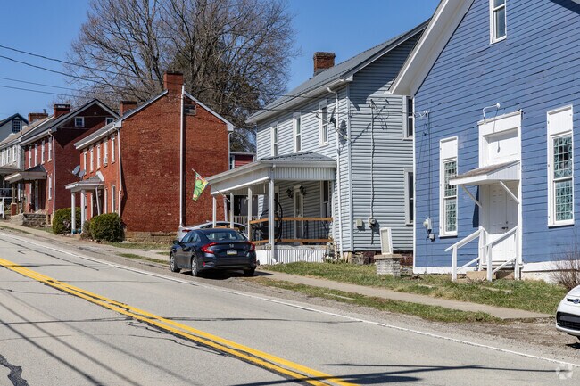 Large residential housing sits close to the road in the downtown area of Hopewell Township.