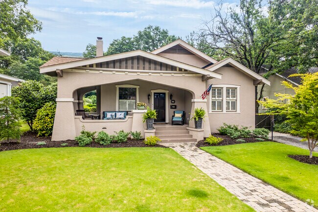 The large porch on this Craftsman Bungalow effortlessly provides an additional living space.