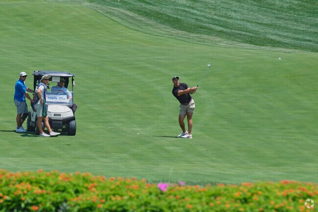 Friends enjoy a game at the TPC Potomac at Avenel golf course in Carderock.