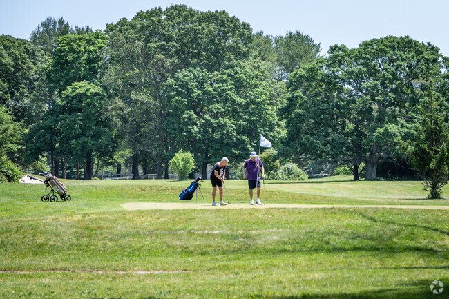 A couple of friends are enjoying their golf game at Potowomut Golf Club in Nichols Corner, RI.