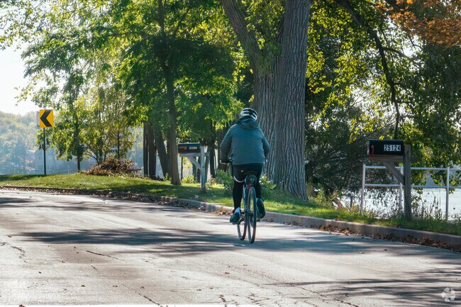 Residents take a scenic bike ride along the shores of Long Lake.