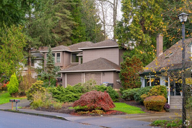 Earth-toned traditional homes blend into the Douglas Firs of the Derry Dell community.