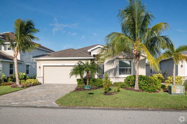 Single-story Harlem Heights ranch home with peaked gables and two car garage.