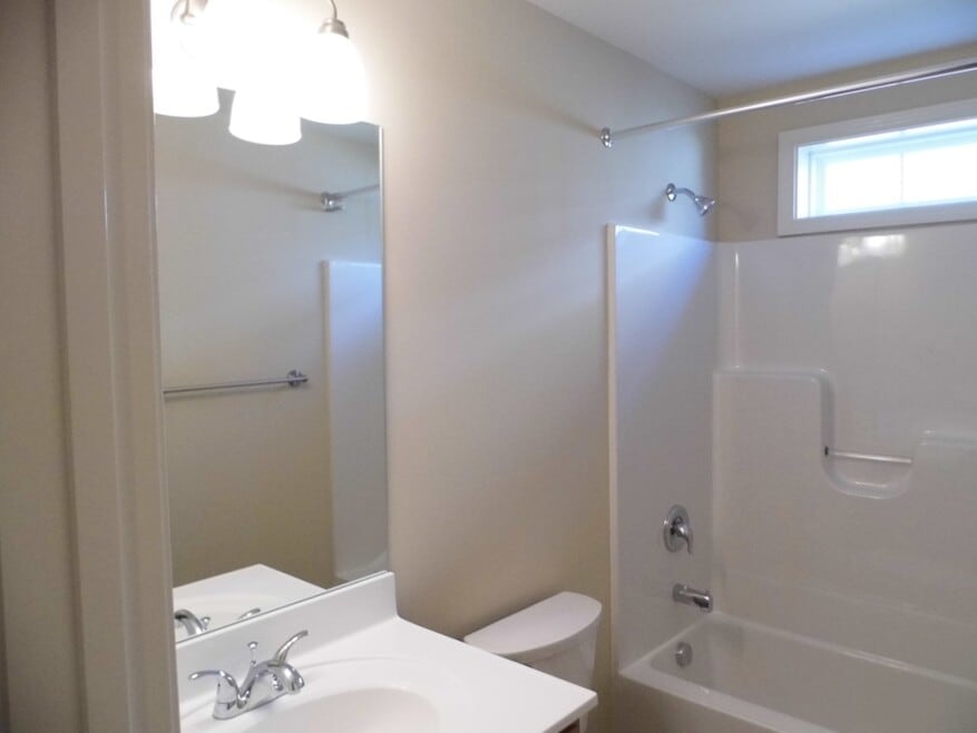 The full bath offers a counter height vanity, large mirror