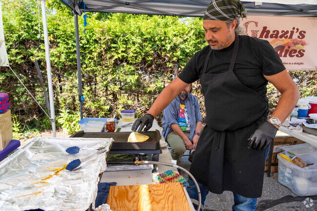 A chef at Ghazi's Goodies prepares mtubka during the farmers' market near Northfield Street.