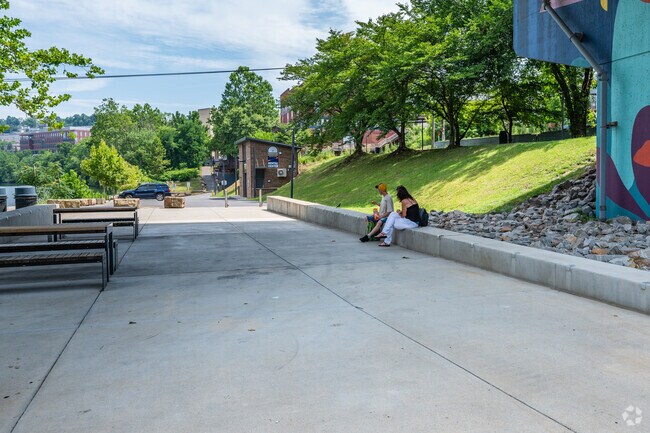 Walkers on the path at Hazel Ruby McQuain Park can sit and look out over the Mon River.