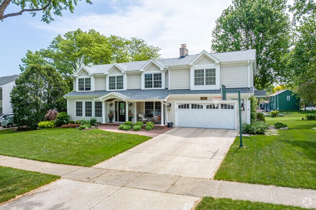 Colonial home in Brush Hill with big deck overlooking DuPage River Trail and river.