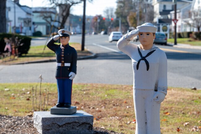 A Marine and Sailor salute the memorial for Veterans in West Brookfield.