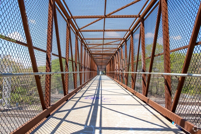 A pedestrian bridge in Bunker Hill-Tower View crosses train tracks for easy access.