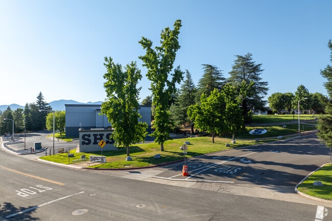 Lush trees provide Shasta High School with shade.