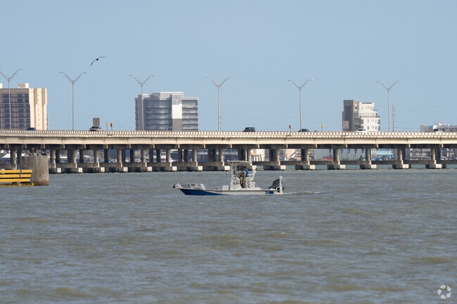 Boats traverse the Laguna bay near Queen Isabella Memorial Causeway.