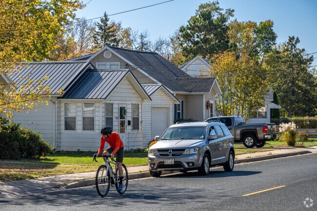 Bikers cruise past rows of homes in Mount Washington.