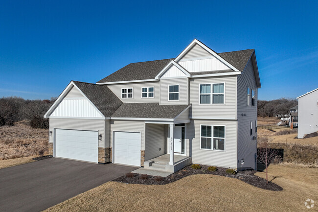 Custom homes with large driveways and expansive lots make up new development in Elk River.